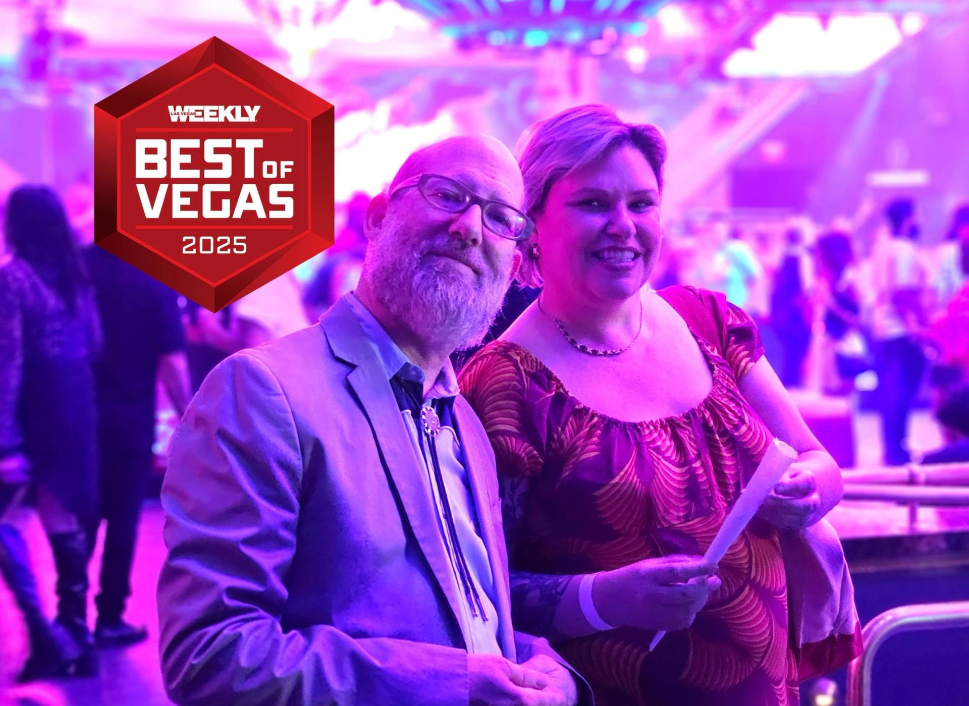 Dayvid Figler and Sarah Lohman holding an award.