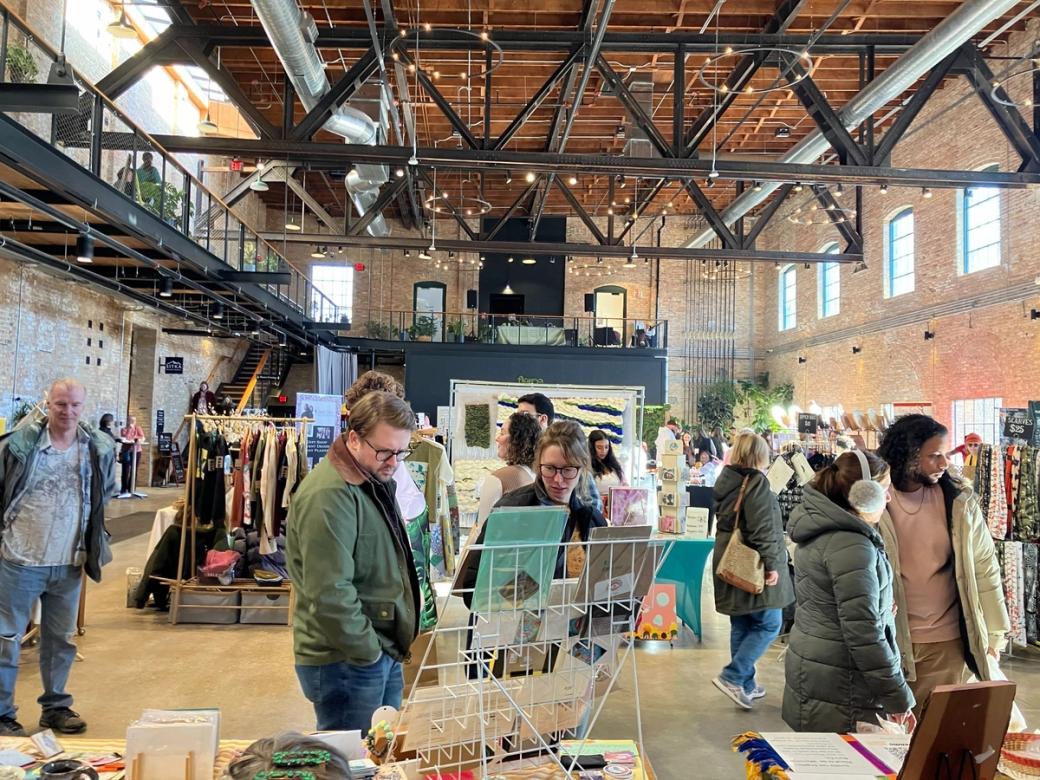 People shopping in a large open, industrial space.