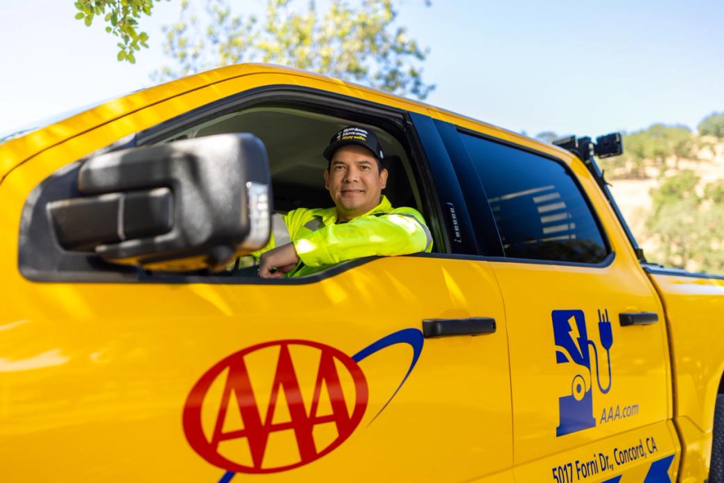 A smiling tow truck driver