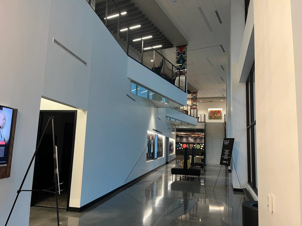 The interior of a building with white walls and a polished floor.
