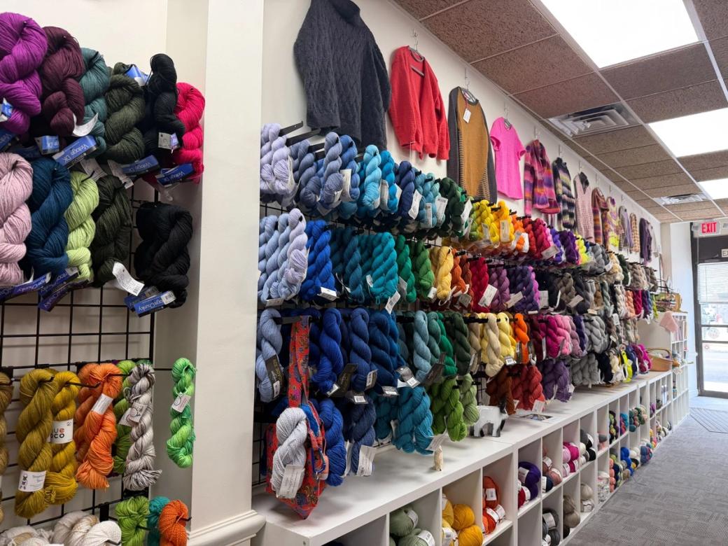 Yarn of every color hangs on the wall at Wildchild Stitches in Garfield.