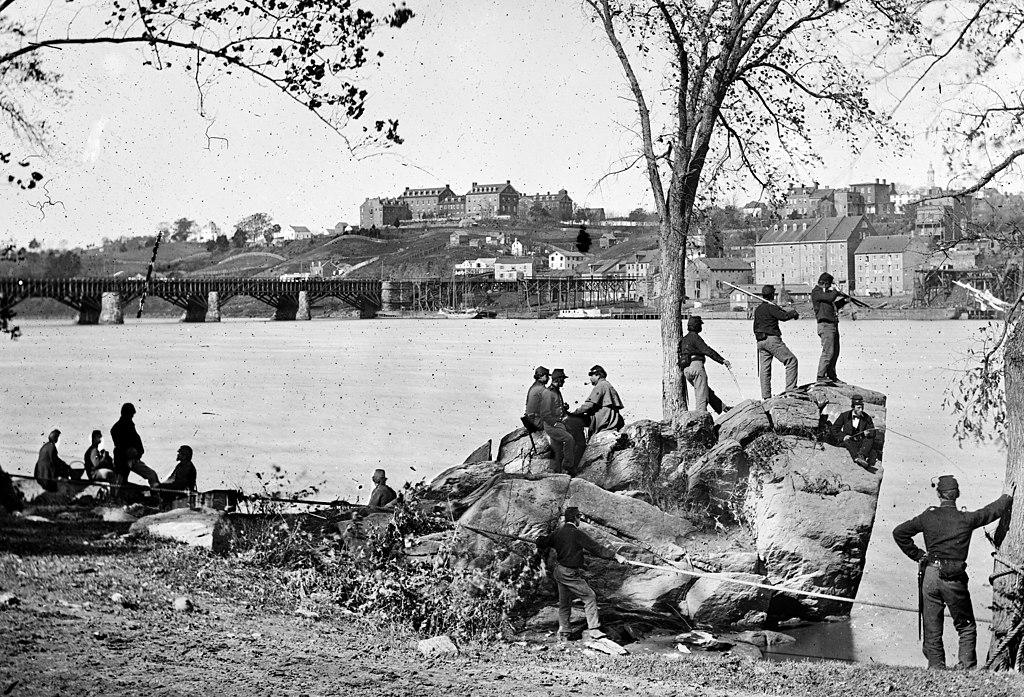Union soldiers on the Mason's Island (Theodore Roosevelt Island) in 1861. Behind them is the Potomac Aqueduct Bridge and Georgetown University on top of the hill. (George N. Barnard/Wikimedia Commons)