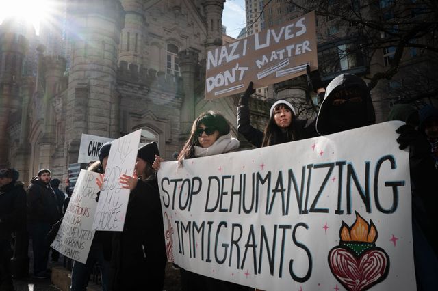 Activists protest the agenda of President Donald Trump on the Magnificent Mile Saturday.
