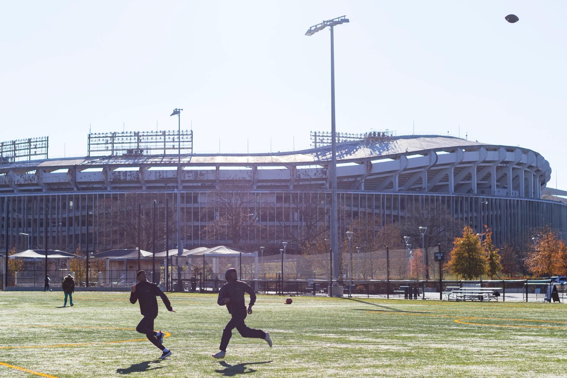 Two people playing football near RFK stadium