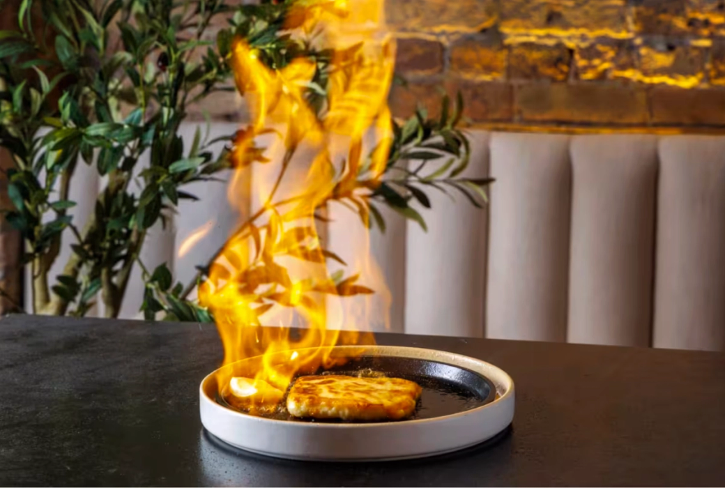 Cheese on fire at the Ithaki Estiatorio Greek restaurant.