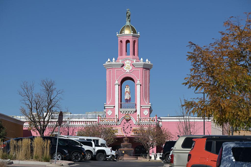 Pink Casa Bonita restaurant building in Denver with a view from the parking lot