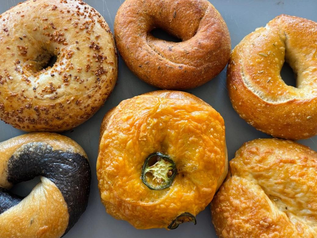 Overhead photo of six different bagels.