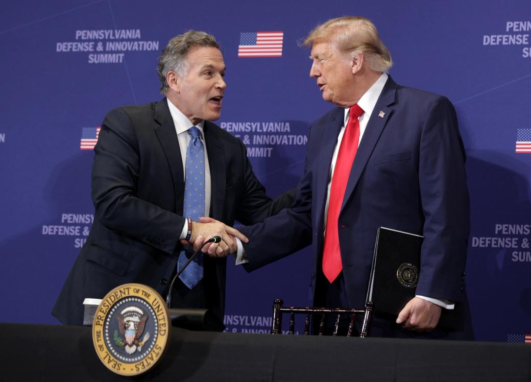 U.S. Sen. Dave McCormick (left) shakes hands with President Donald Trump (right)