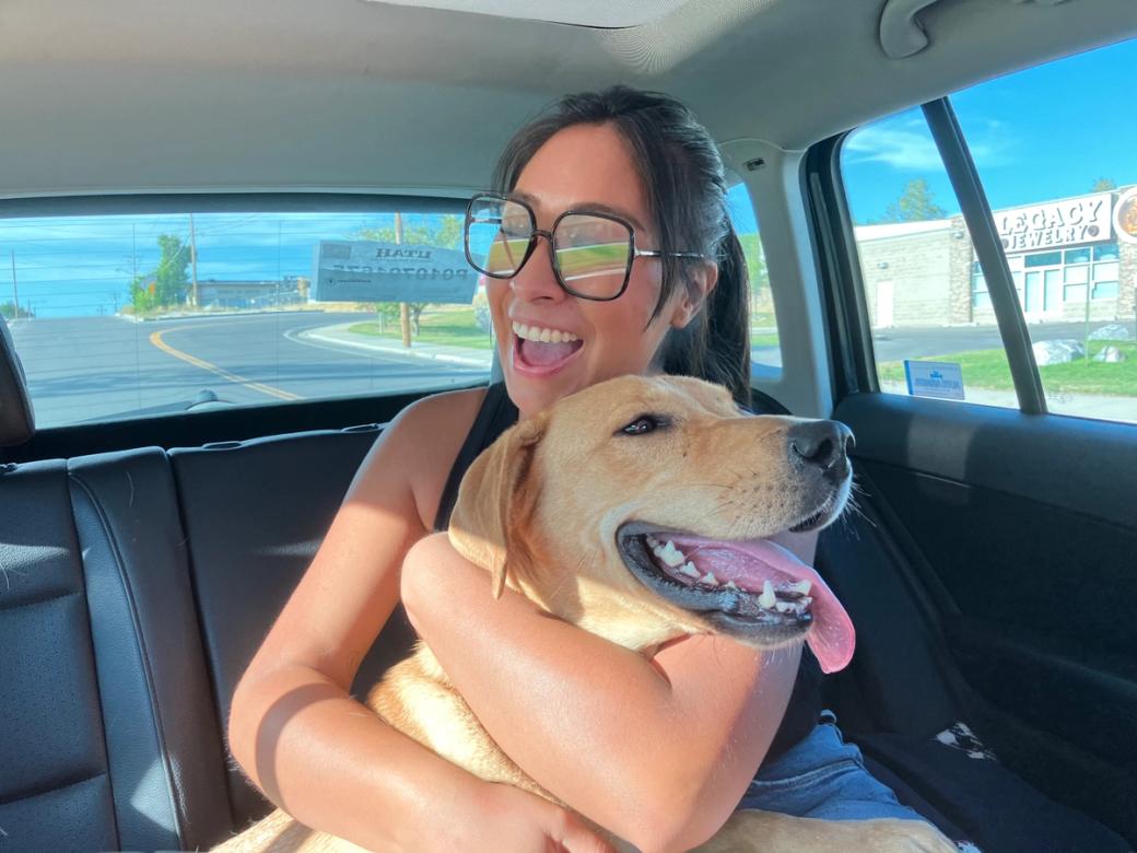 A girl hugging her dog.