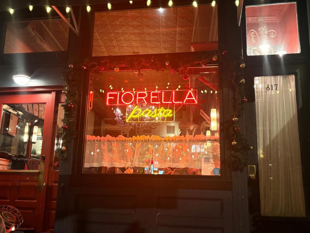 Neon sign of "Fiorella Pasta" on the restaurant's front window