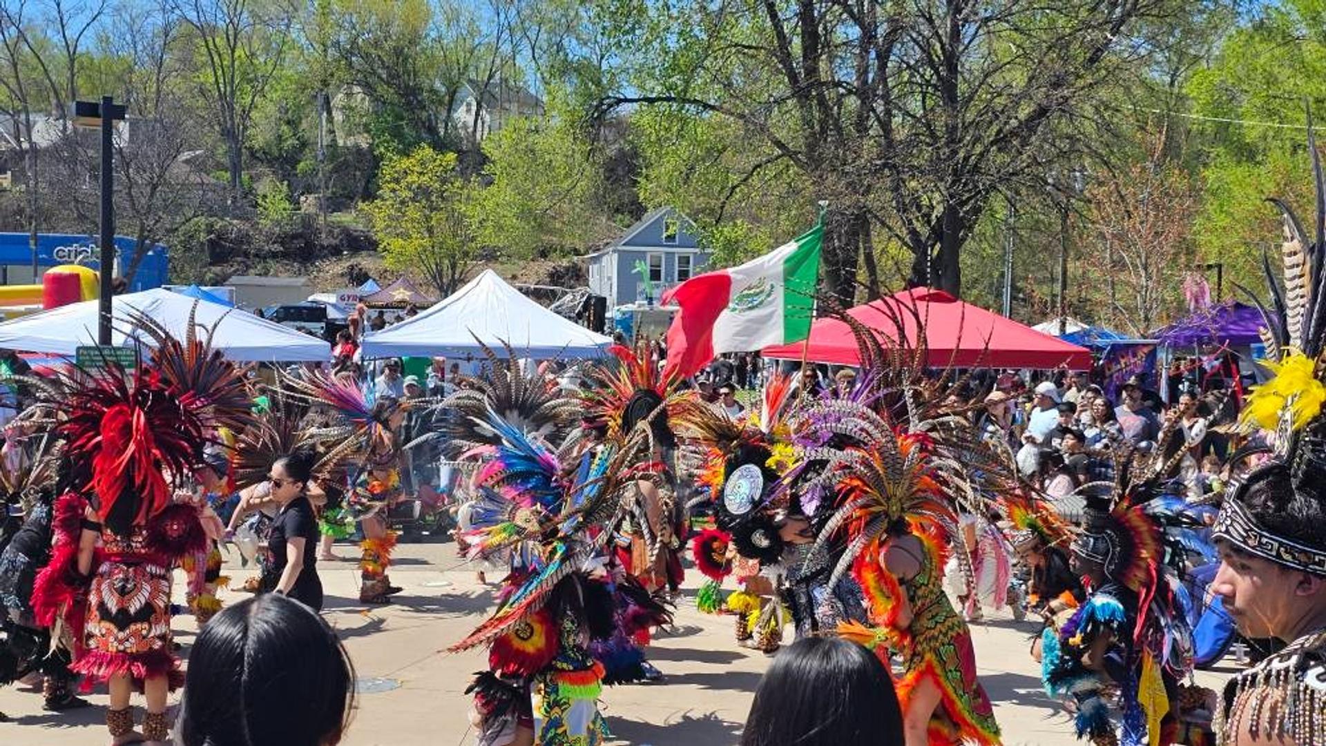 A group of people dressed in aztec clothing dancing