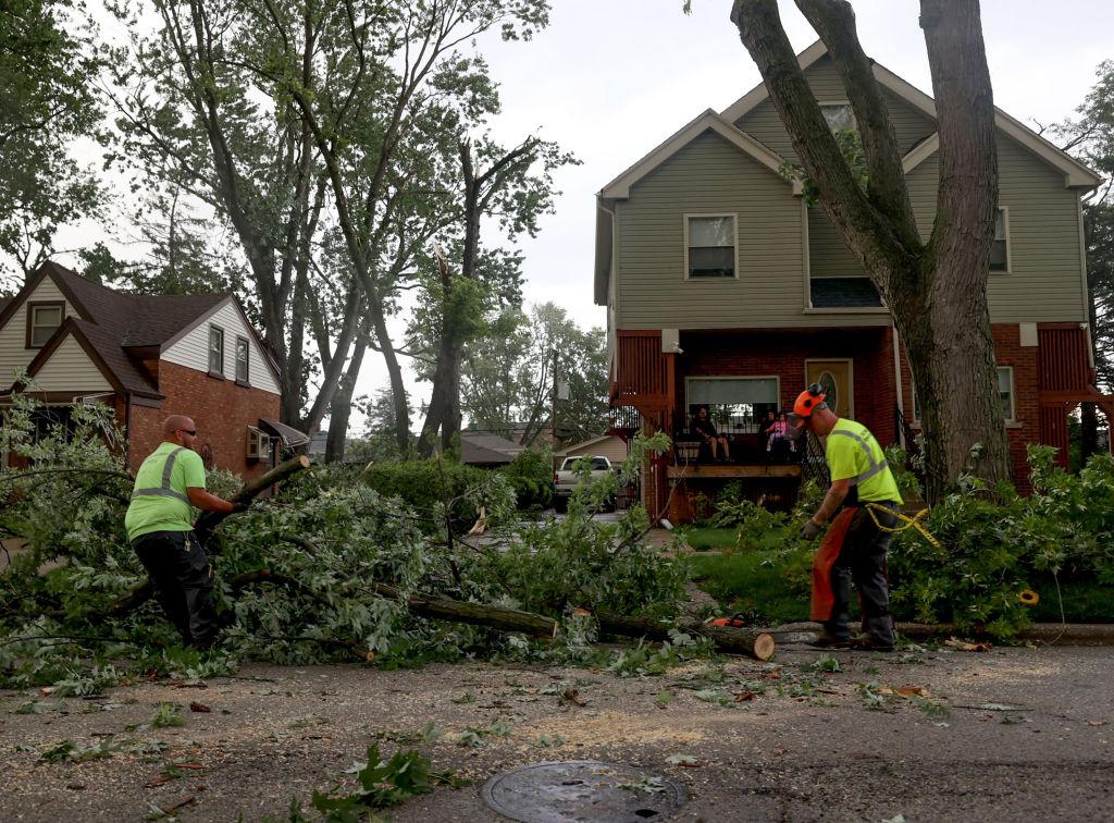 Workers clear branches after storms in Stickney, Illinois, July 12