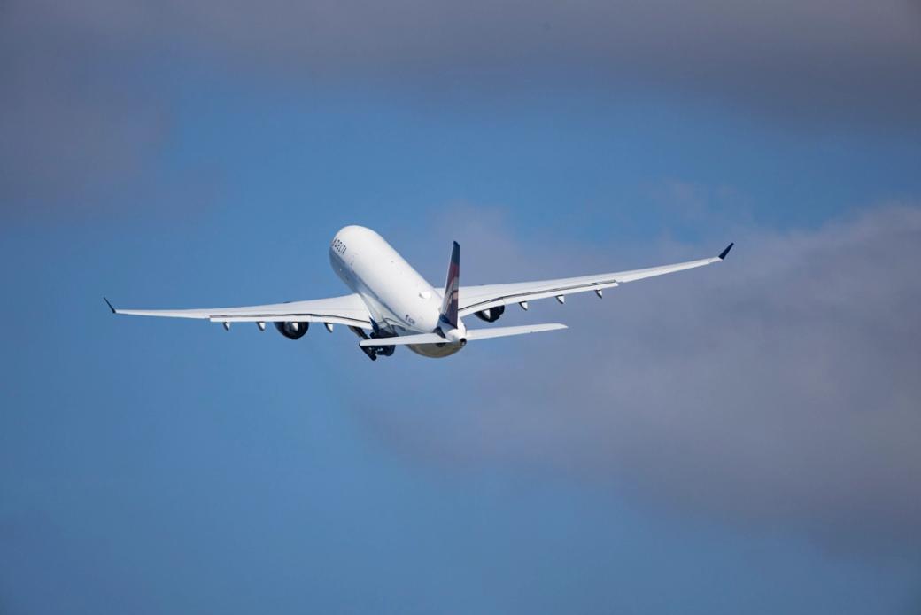 A plane flies out of the Minneapolis–Saint Paul International Airport 