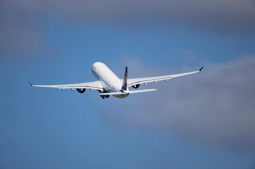 A plane flies out of the Minneapolis–Saint Paul International Airport