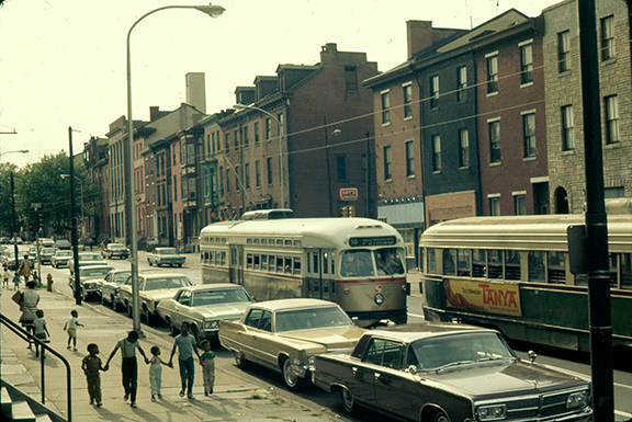In 1971, five children walk down the 1400 block sidewalk of Girard Avenue hand in hand.