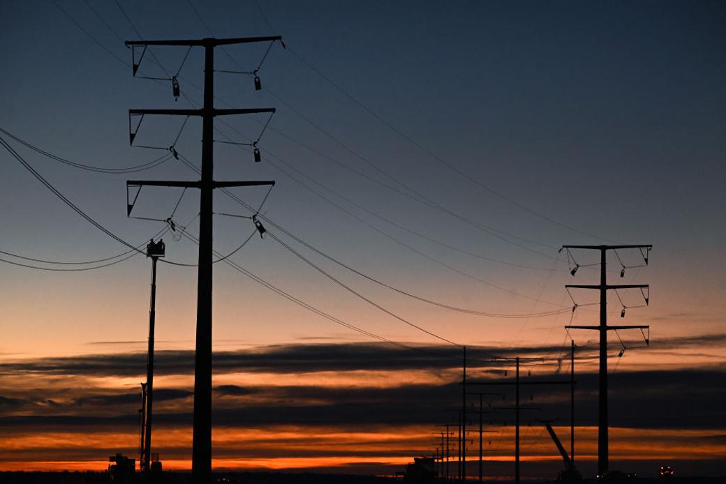 Power lines with sunset in the background