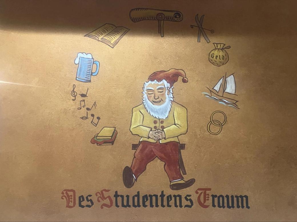 A drawing of a bearded dwarf on a brown wall.