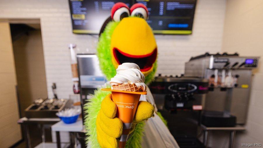 The Pirate Parrot holding a tiny orange traffic cone, with an ice cream cone inside.