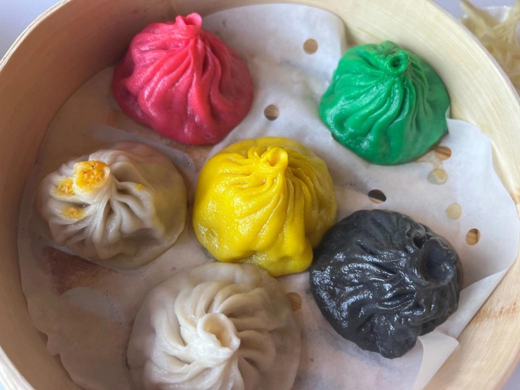 Tray of six bao dumplings in different colors