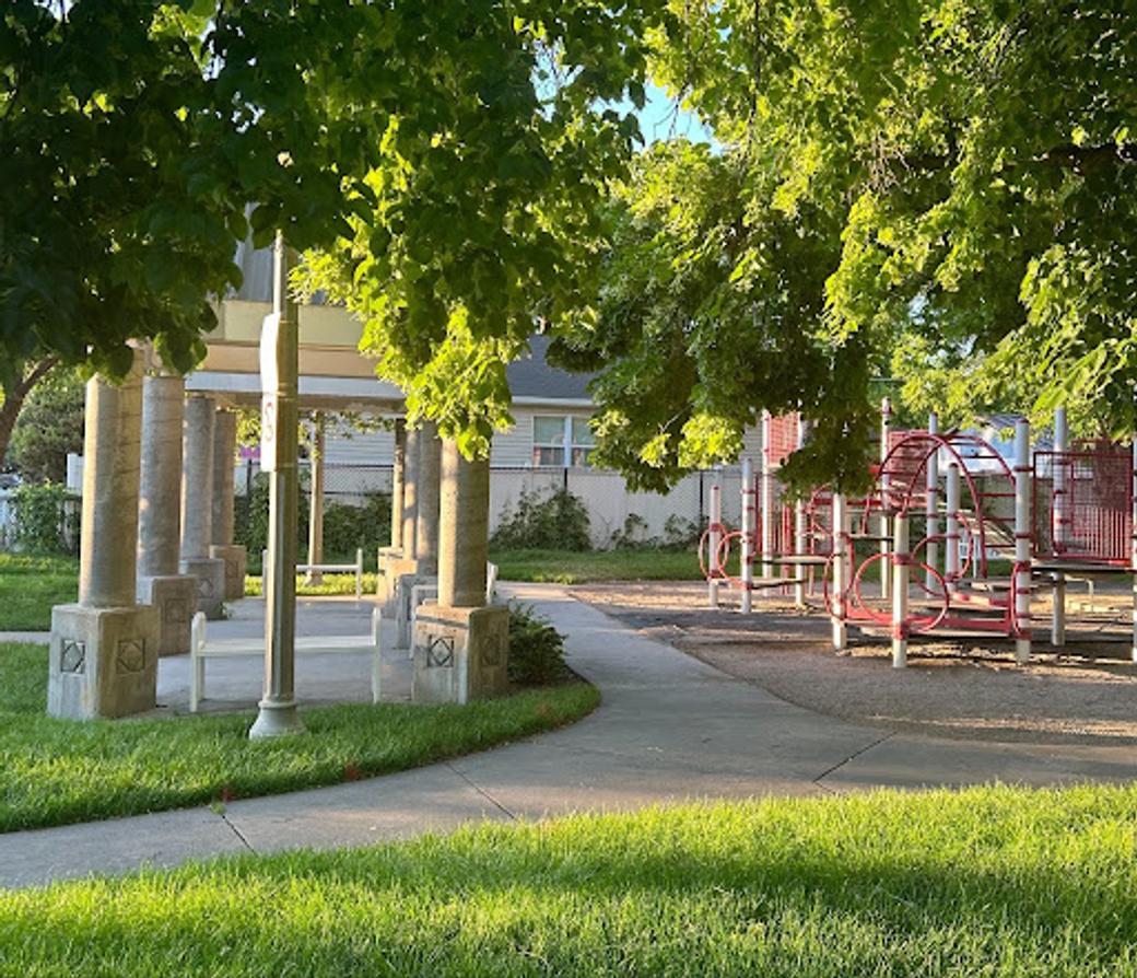 A playground at a park in Salt Lake City at sunset. 