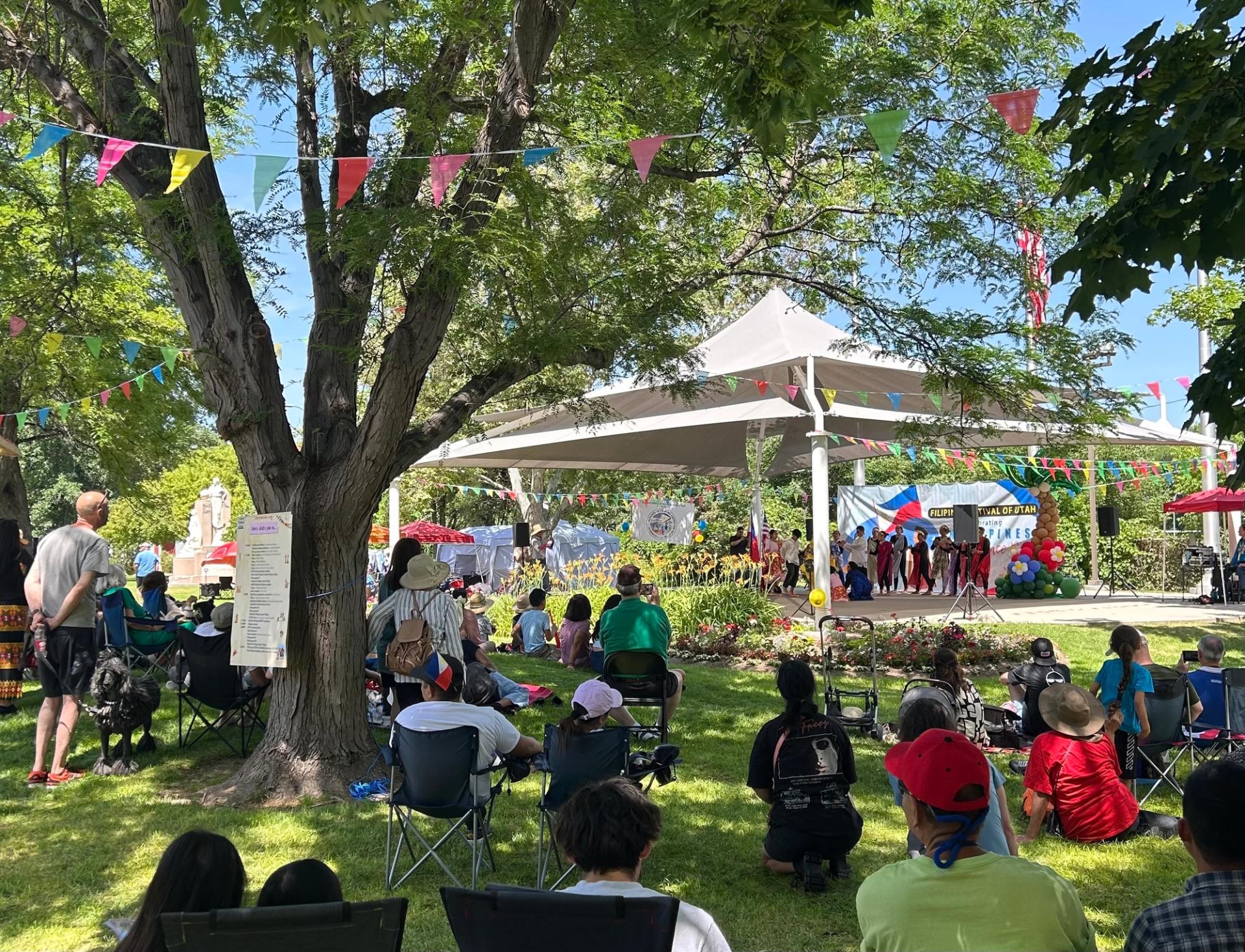 A crowd gathers in the International Peace Gardens to watch performers at the Filipino Festival of Utah.