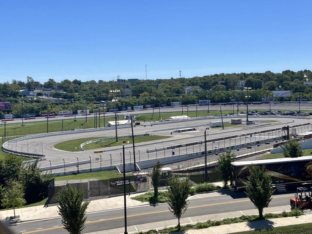 A race car track surrounded by trees.