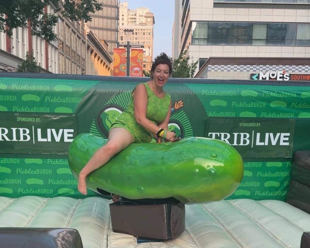 Our own Rachel Carlson rides the mechanical pickle.