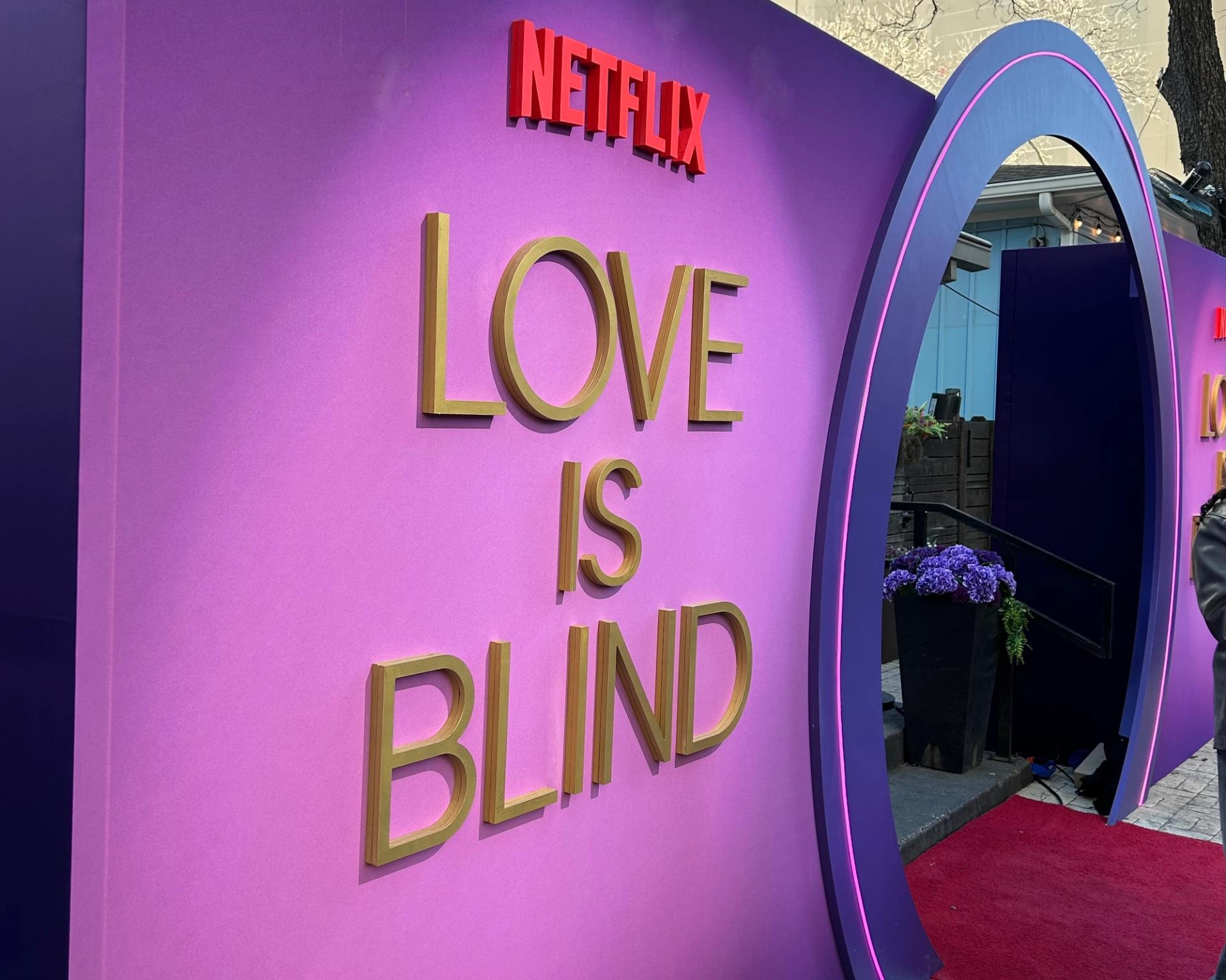 A purple wall that reads "Netflix Love Is Blind."