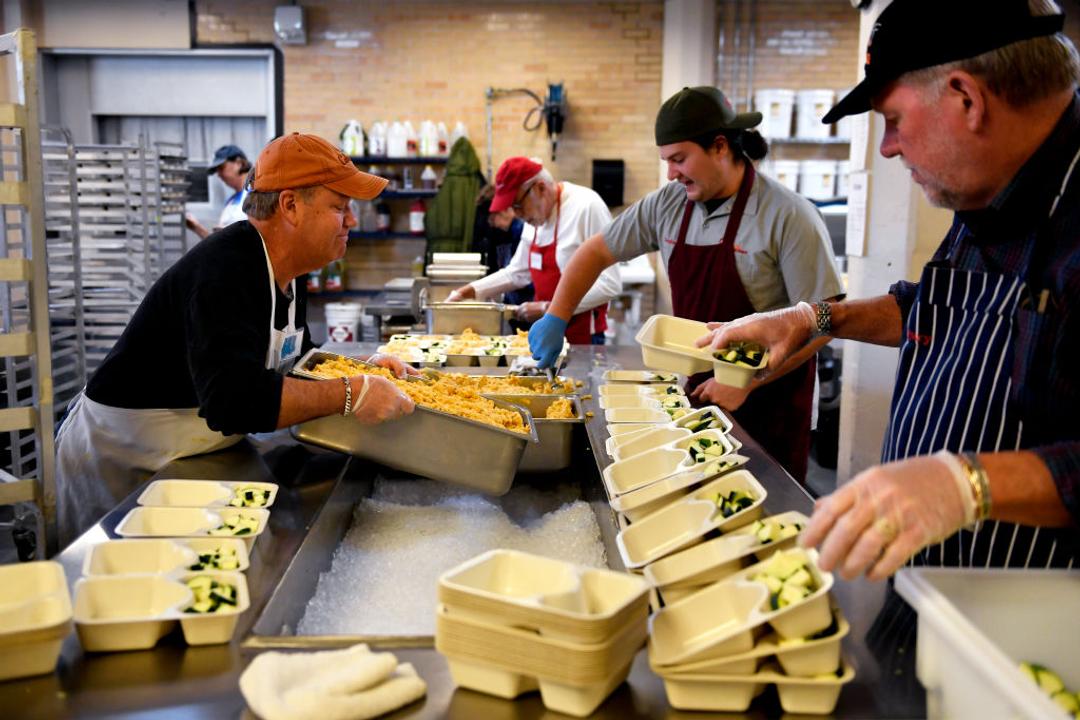 Project Angel Heart volunteers package meals for delivery.
