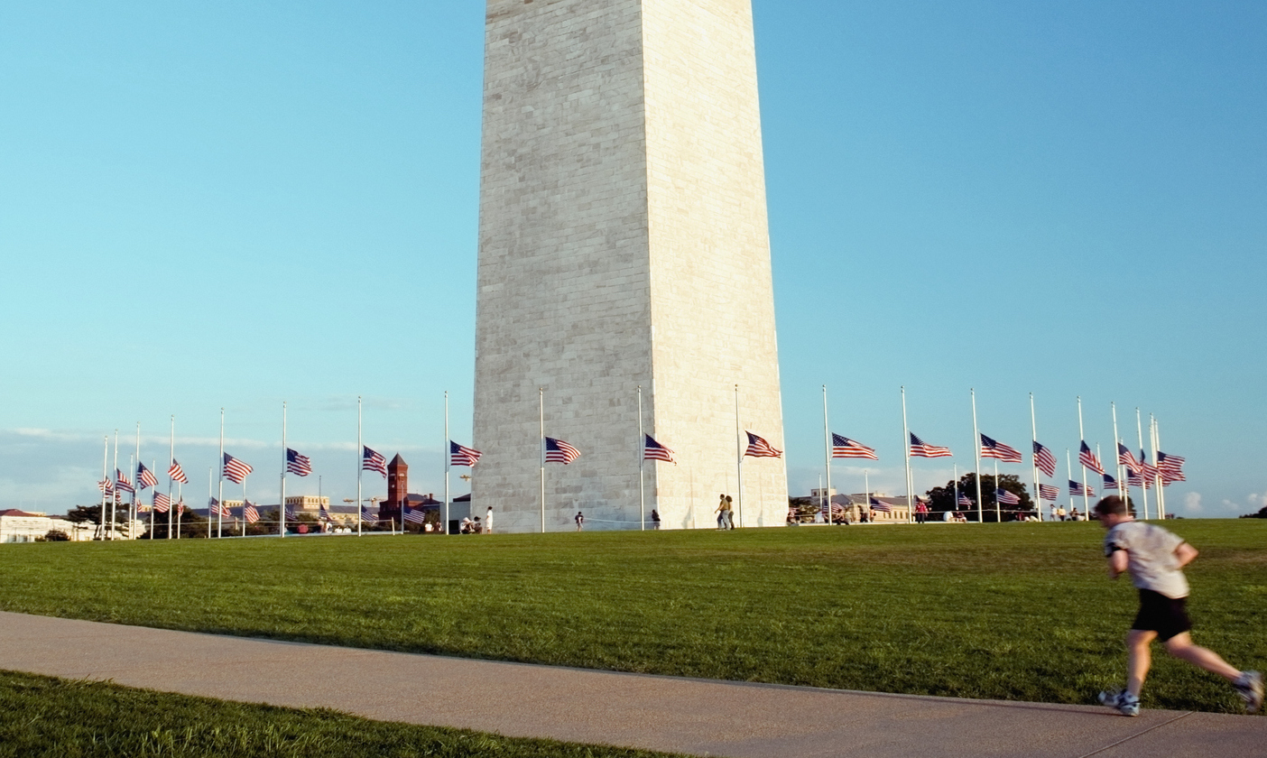 A person running outside the Washington Monument