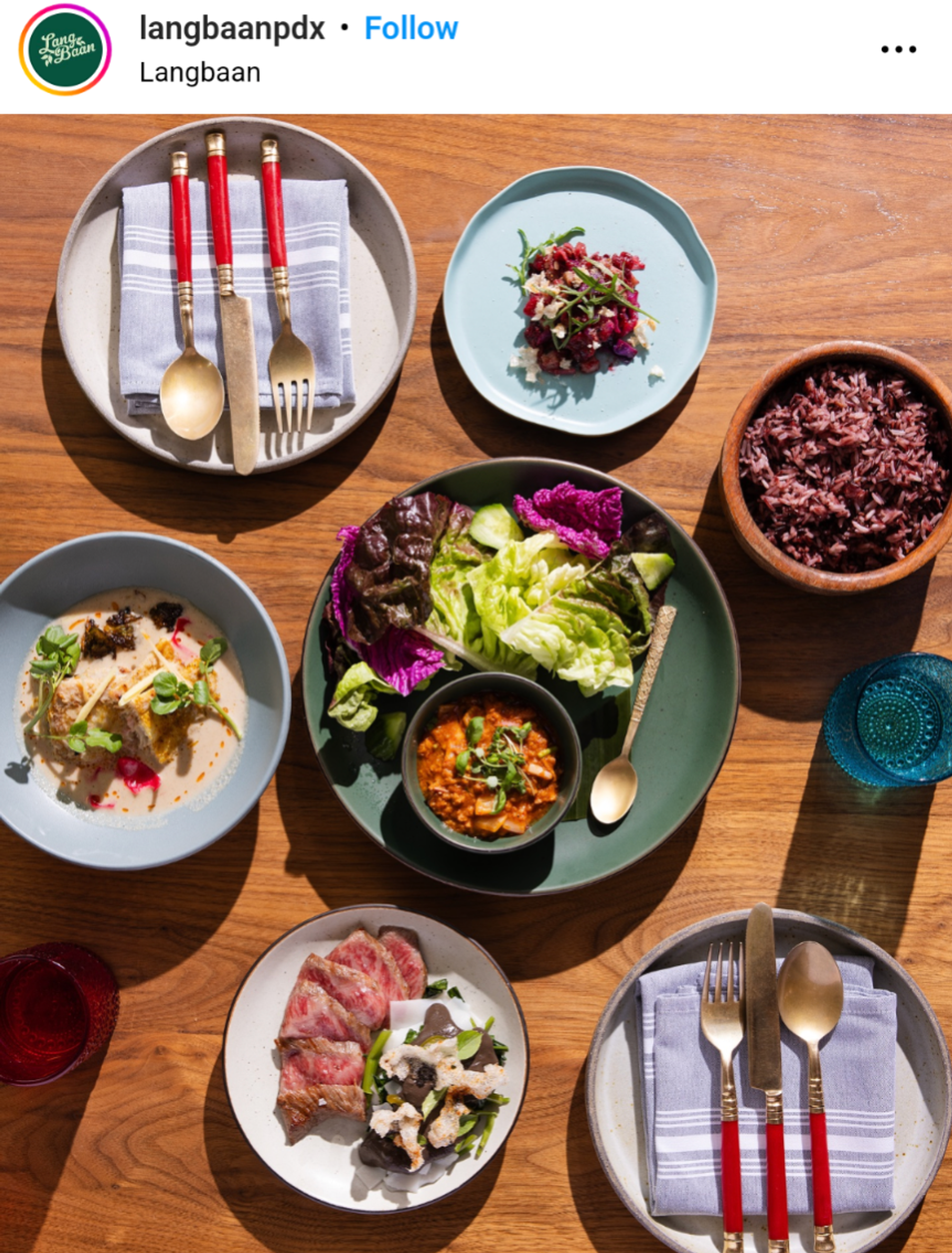 six plates and blue glass cup displaying a feast