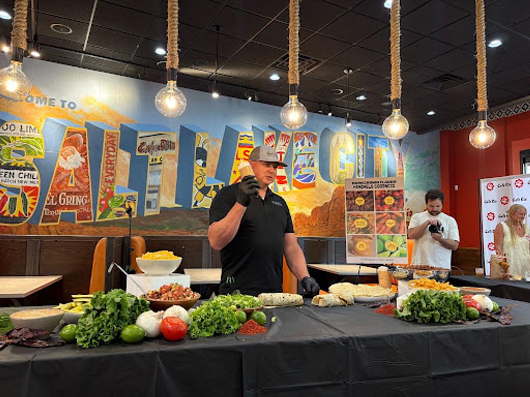 Cafe Rio’s VP of Operations Chris Reading demonstrating their new Utah handheld burrito. (Ivana Martinez/City Cast Salt Lake) 