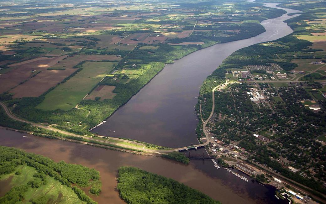 The brown-hued waters of the St. Croix and Mississippi, surrounded by greenery from the land.
