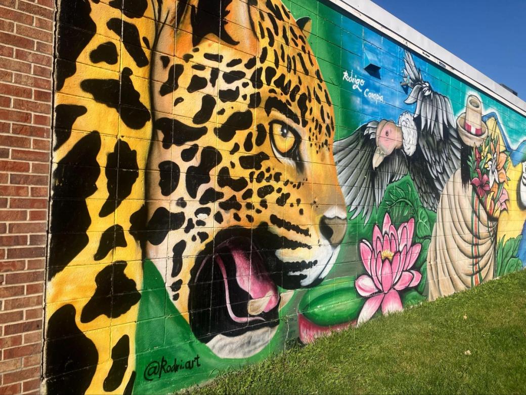 A mural of a tiger on a brick building.