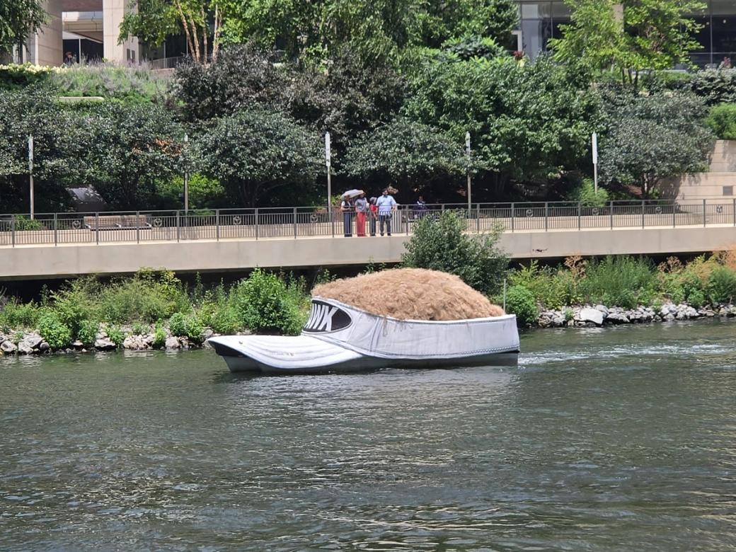 A big hat shaped float on a river