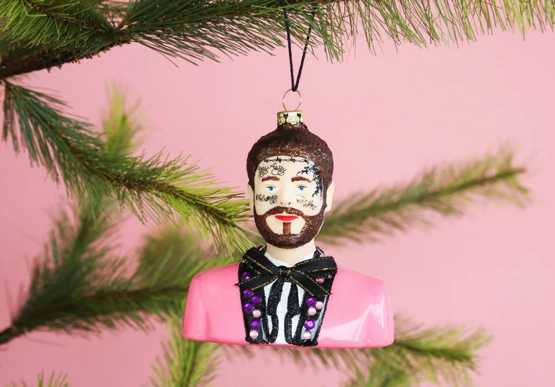 Post Malone ornament hanging on a tree branch.