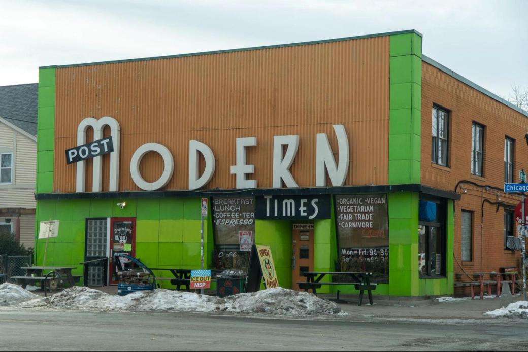 The brown-and-lime-green exterior of Post Modern Times, and the street in front of the restaurant.