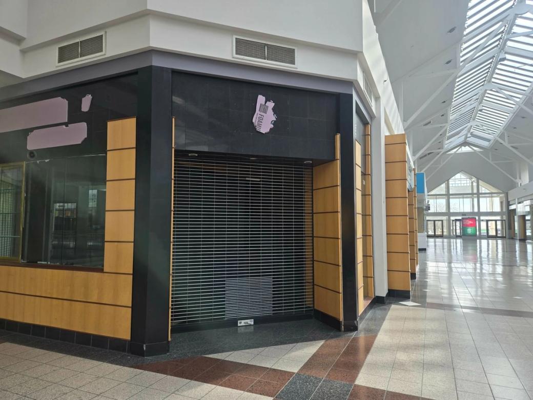 An empty store on the corner of a mall