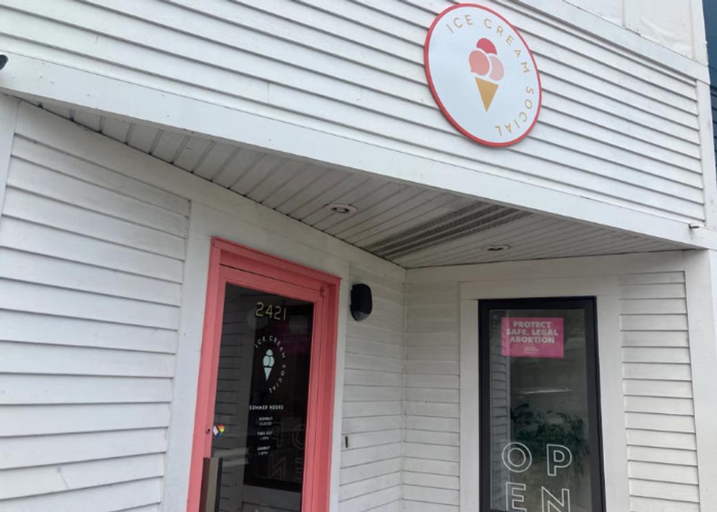 An outside shot of Ice Cream Social. The front door is pink.