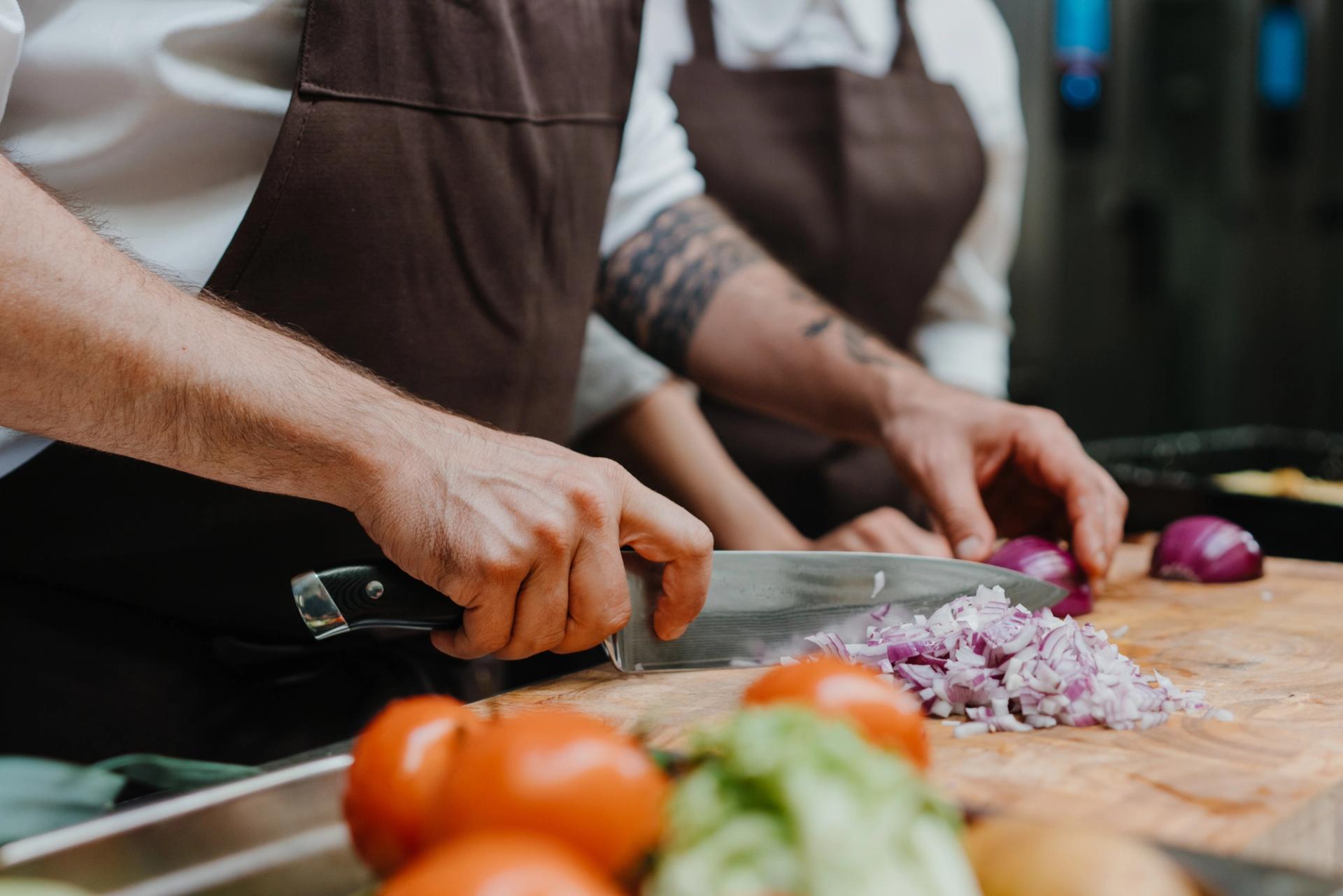 A person cutting vegetables.