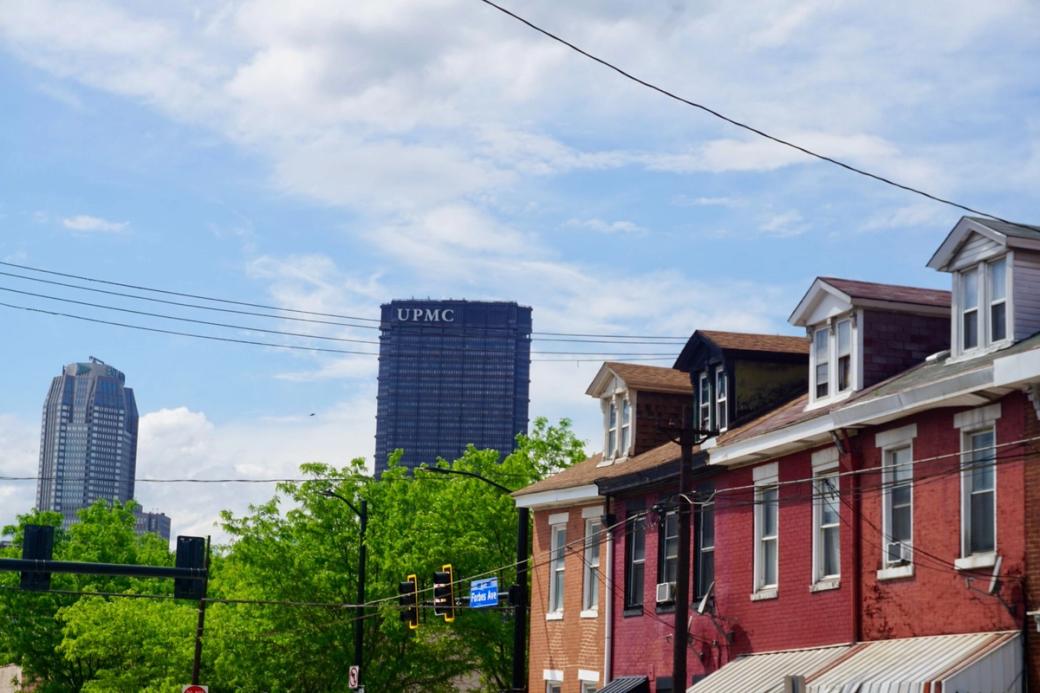 View of homes with Pittsburgh skyline in the background.