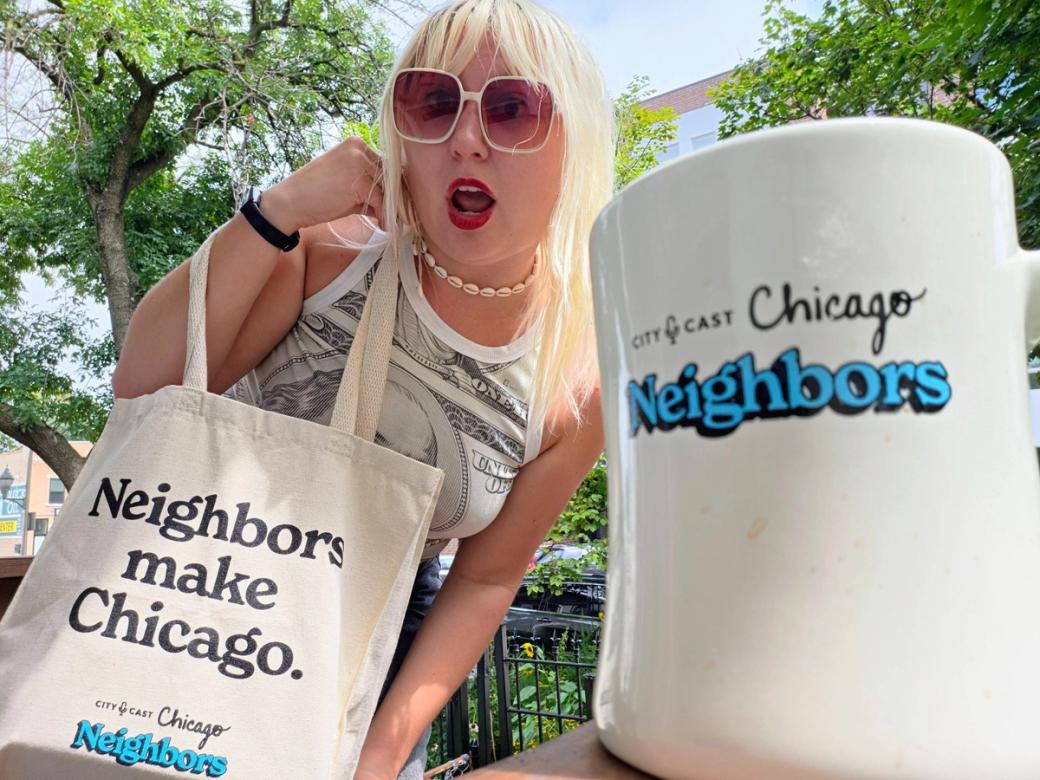 A woman in sunglass holding a tote bag that says "Neighbors make Chicago" and in the foreground there's a mug that says "CityCast Chicago Neighbors"