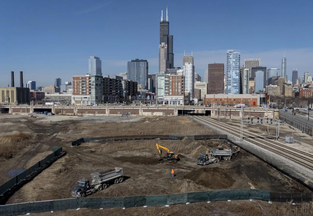 A large dirt lot with construction being started