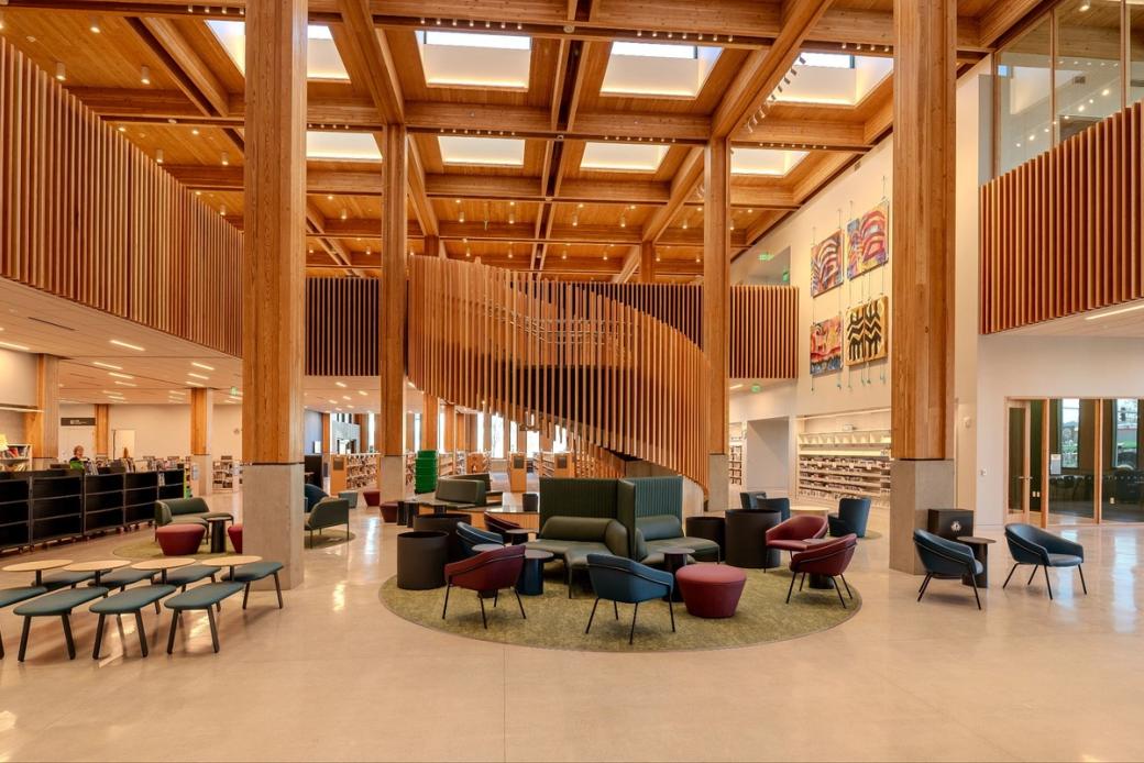 Exposed wood beams and staircases line the central room of the library.