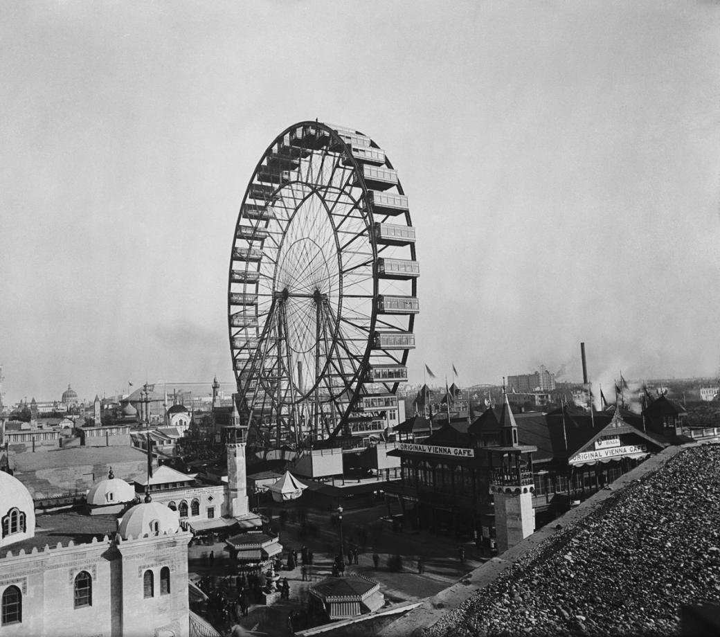 A black and white photo of a ferris wheel