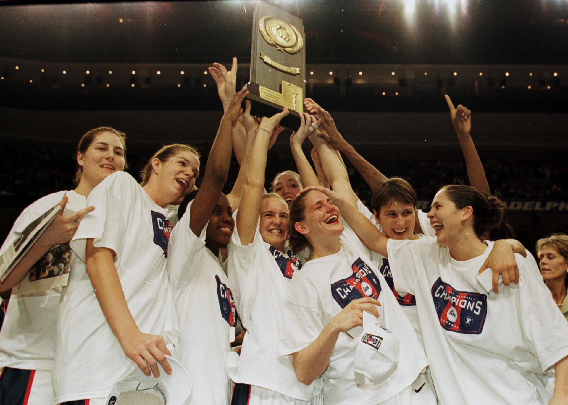 A women's college basketball team celebrating its success.