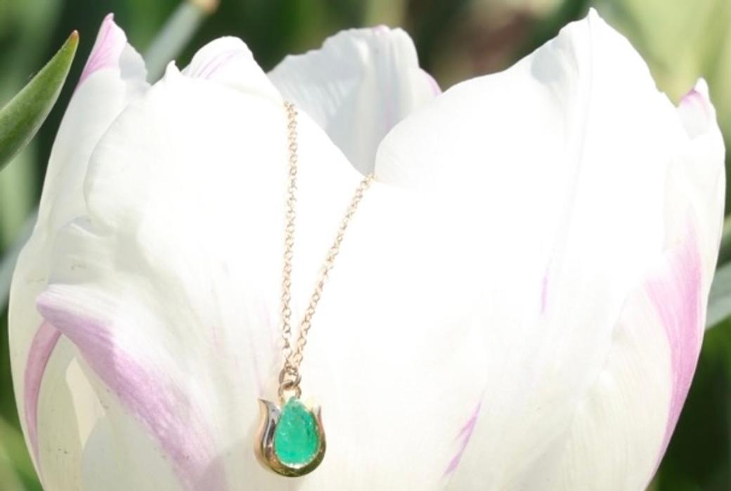 Display ad for Beaumont Jewelry: emerald tulip necklace
