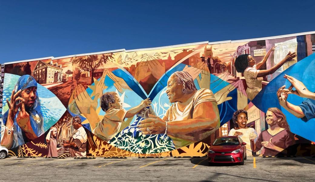 A mural depicting people using ASL