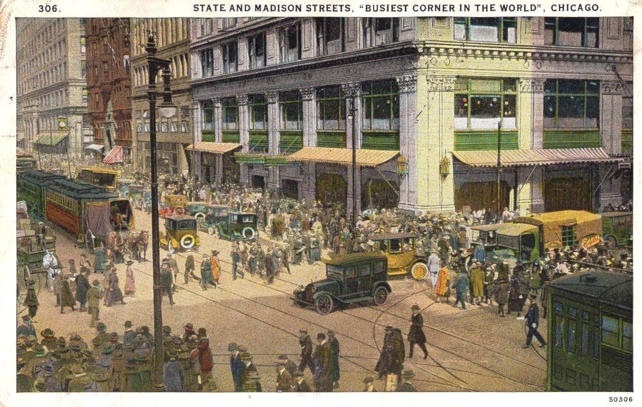 Vintage postcard of State and Madison showing two first-generation Yellow Cabs around 1917