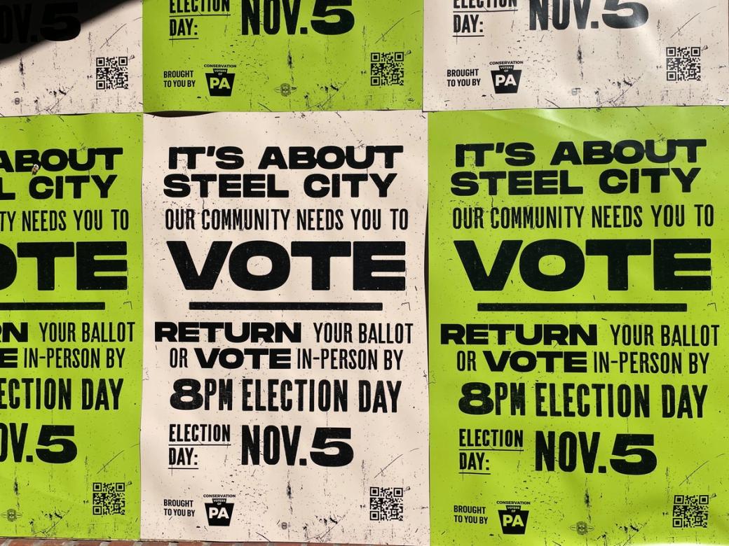 white and green flyers that say "It's about steel city our community needs you to vote"